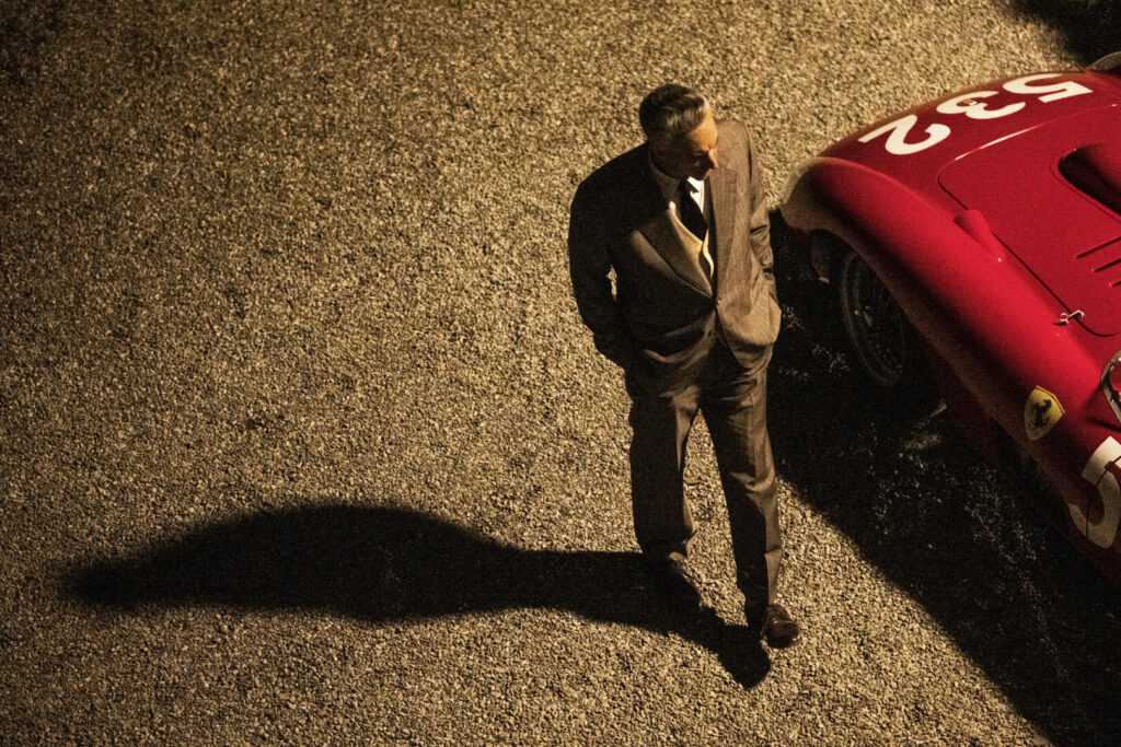 Adam Driver as Enzo Ferrari (red). Photo Credit Lorenzo Sisti