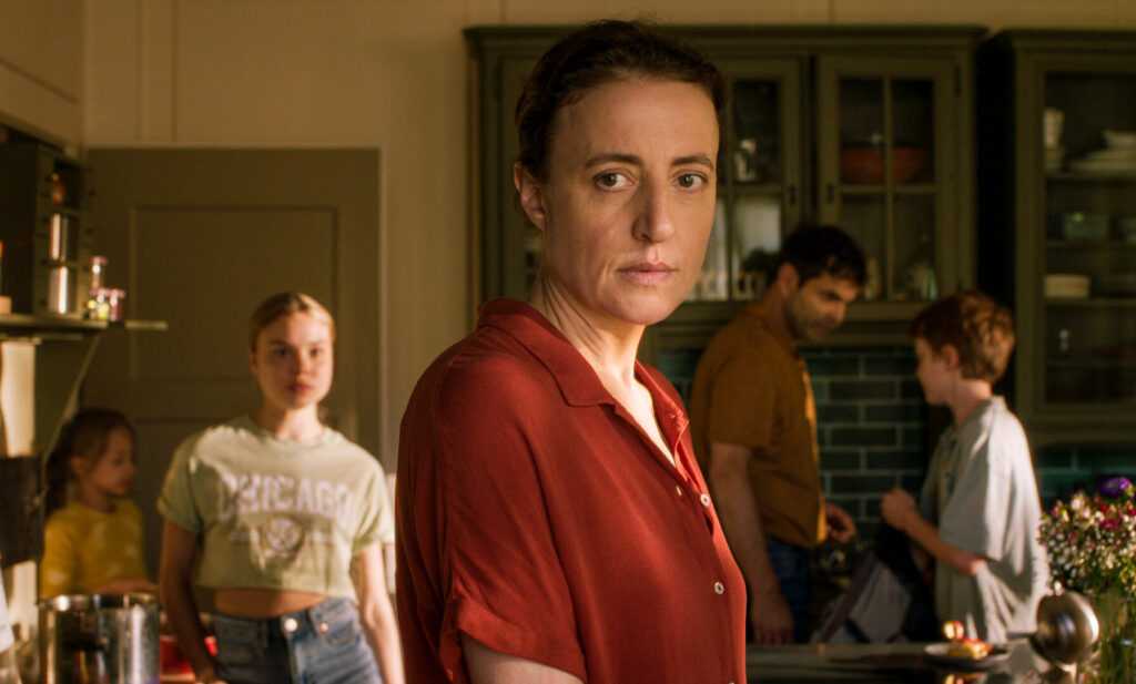 A film still from The Sparrow and the Chimney featuring Karen and family in kitchen