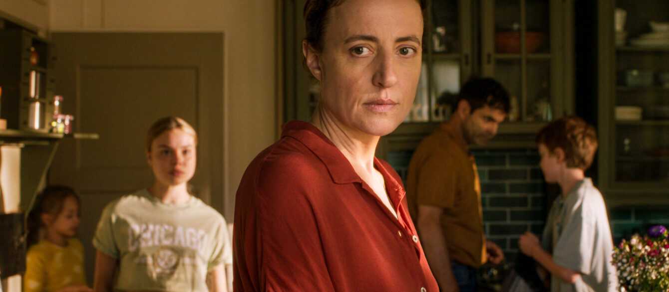 A film still from The Sparrow and the Chimney featuring Karen and family in kitchen