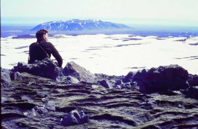 A film still from Time and Water. Icelandic Glaciological Society member, Árni Kjartansson, sits overlooking a glacier in Iceland. (Archival Materials Courtesy of Andri Snær Magnason)