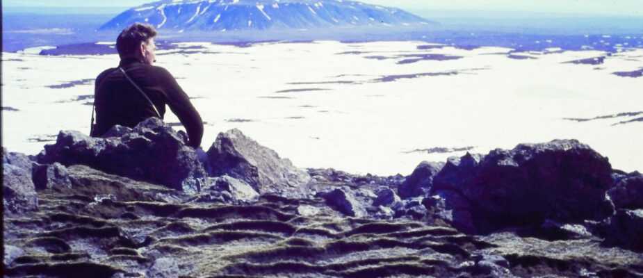 A film still from Time and Water. Icelandic Glaciological Society member, Árni Kjartansson, sits overlooking a glacier in Iceland. (Archival Materials Courtesy of Andri Snær Magnason)