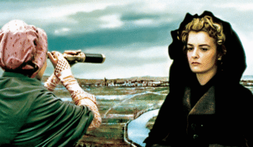 A woman in a dark coat looks away while another woman views the landscape through binoculars in a scene from The Lady and the Duke.